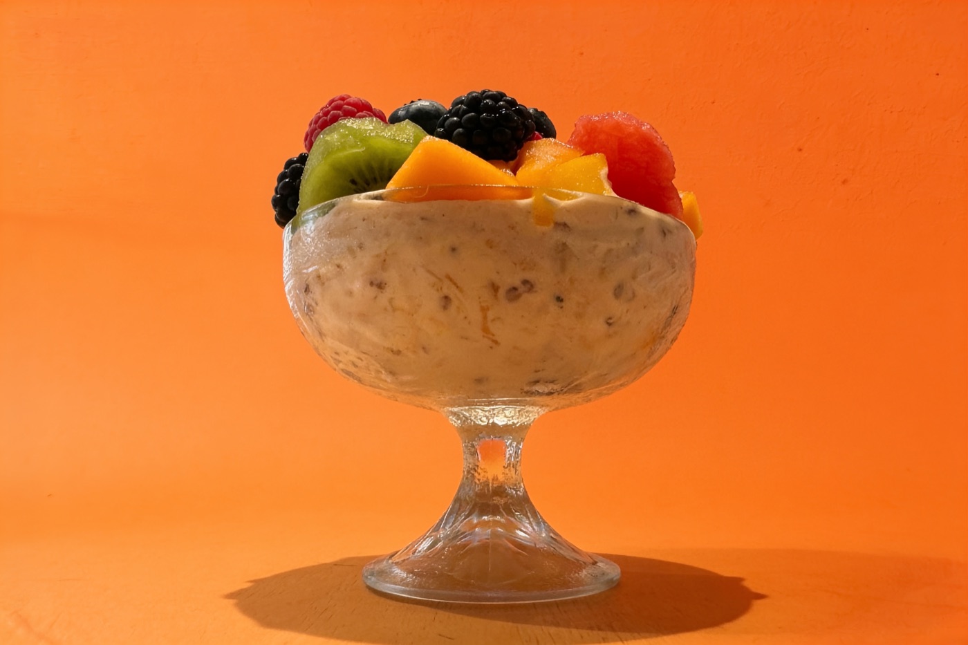 Bircher Müsli mit frischen Früchten und Beeren im Glasschälchen